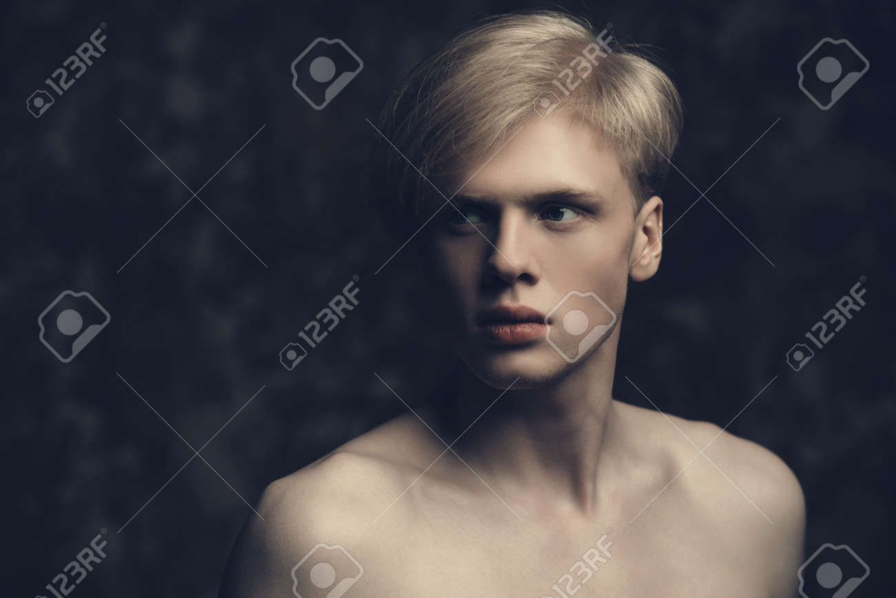 Portrait Of A Shirtless Young Man With Blond Hair Posing At Studio