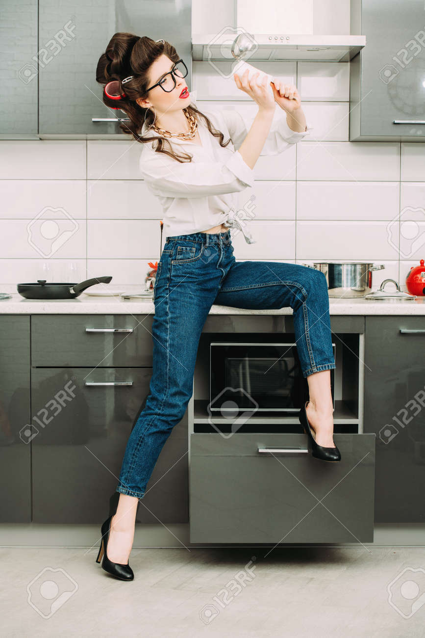 Beautiful Girl Is Posing In Everyday Clothes With Curlers In