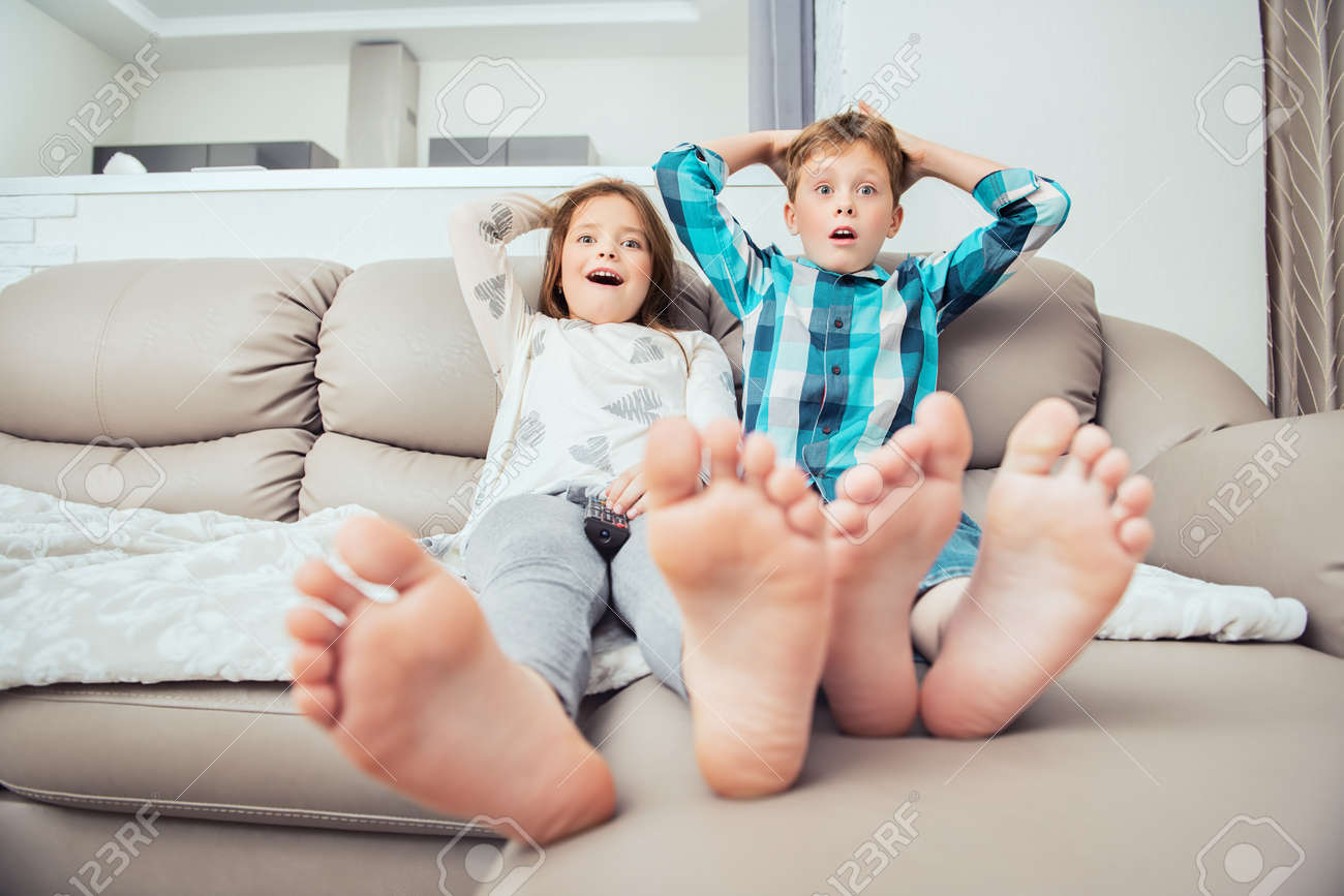 Cute boy and girl are sitting on the couch. Fashion home shot. Childhood. Kid's fashion. - 119532467 Cute boy and girl are sitting on the couch. Fashion home shot. Childhood. Kid's fashion. - 119532467