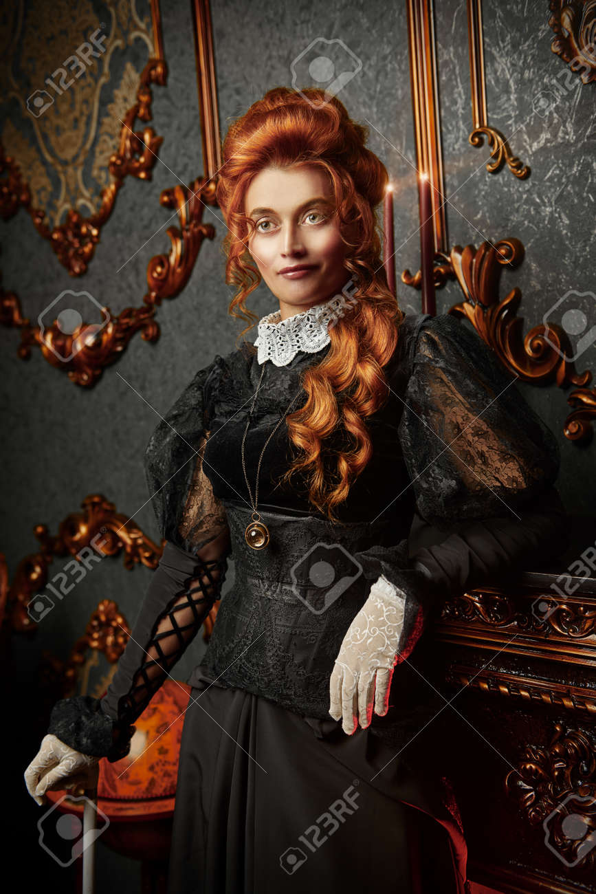 The Victorian era concept. Beautiful woman in elegant historical dress and hairstyle posing in vintage interior. Baroque. Fashion. - 130321418 The Victorian era concept. Beautiful woman in elegant historical dress and hairstyle posing in vintage interior. Baroque. Fashion. - 130321418