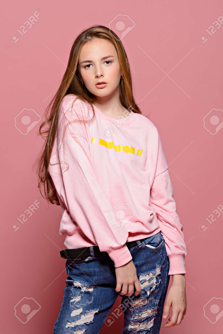 Teen Style. Beautiful Young Model With Long Hair Posing At Studio In Jeans And Pink Sweatshirt. Beauty, Fashion. Stock Photo, Picture And Royalty Free Image. Image 140877404. Teen Style. Beautiful Young Model With Long Hair Posing At Studio In Jeans And Pink Sweatshirt. Beauty, Fashion. Stock Photo, Picture And Royalty Free Image. Image 140877404.