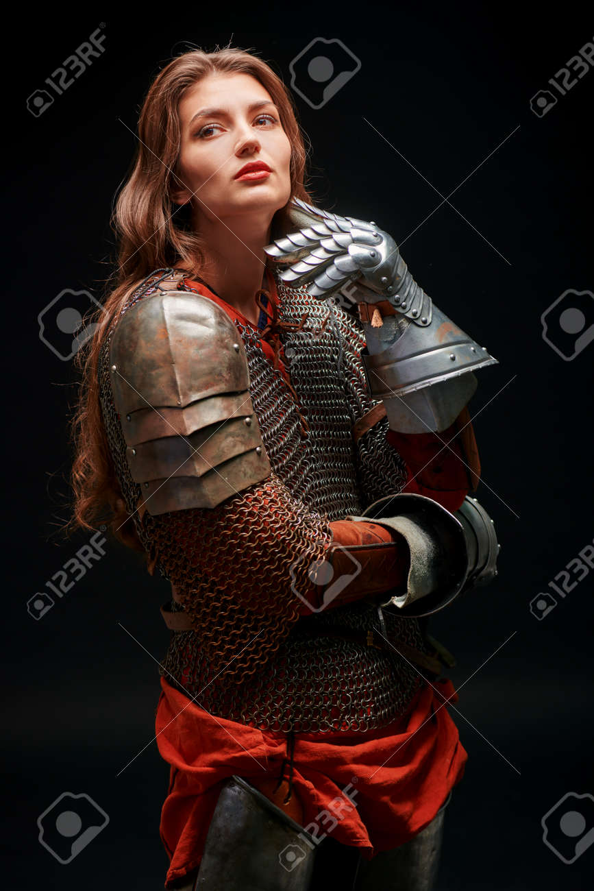 Portrait Of Beautiful Dreamy Medieval Girl Warrior In Chainmail And Plate  Armor Posing On A Dark Background. Stock Photo, Picture and Royalty Free  Image. Image 168321163., image size:867x1300