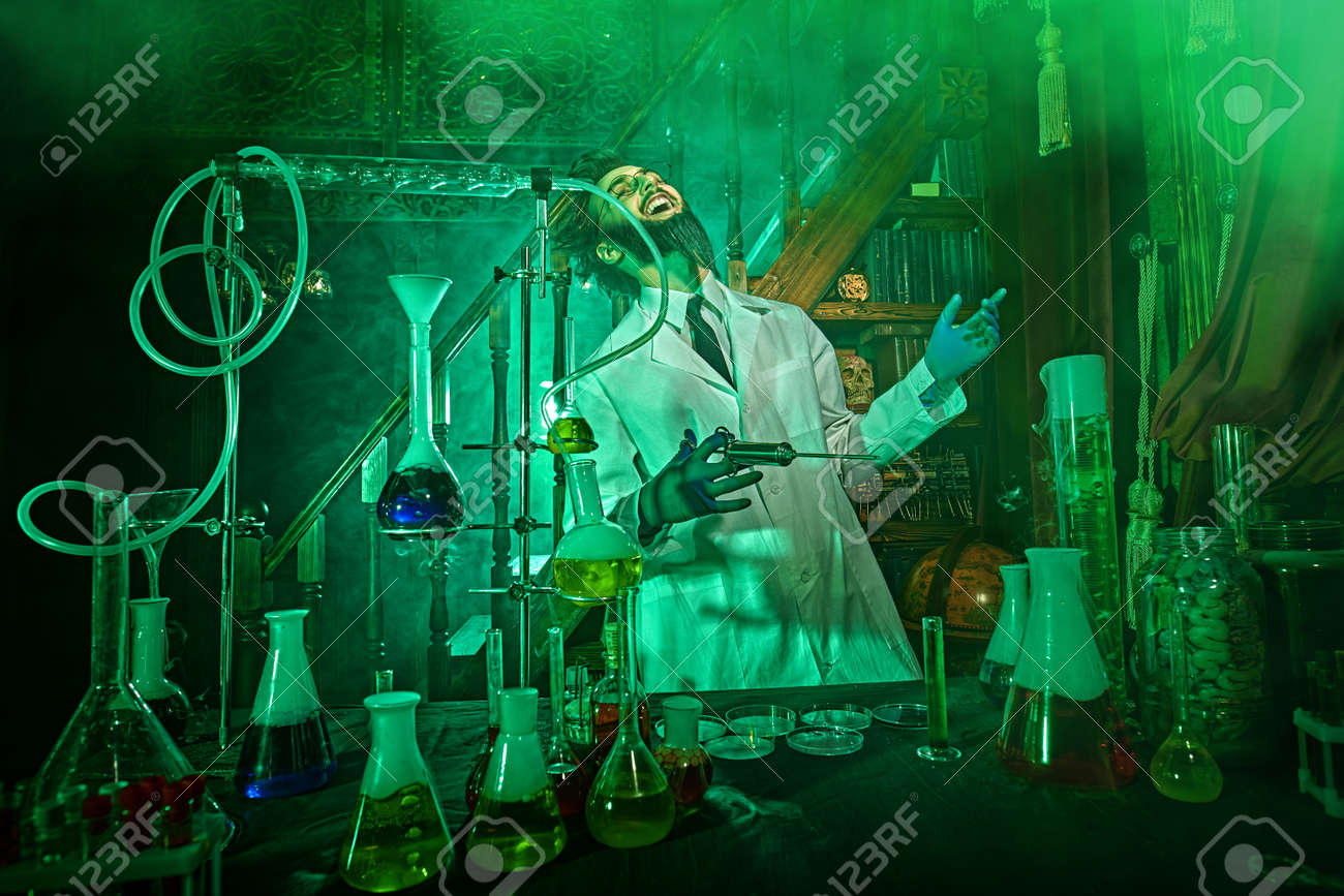 Character Of A Science Fiction Novel. Crazy Scientist Madly Laughs Working  Enthusiastically In His Laboratory, Lit By A Mysterious Green Light. Stock  Photo, Picture and Royalty Free Image. Image 184449797., image size:1300x867