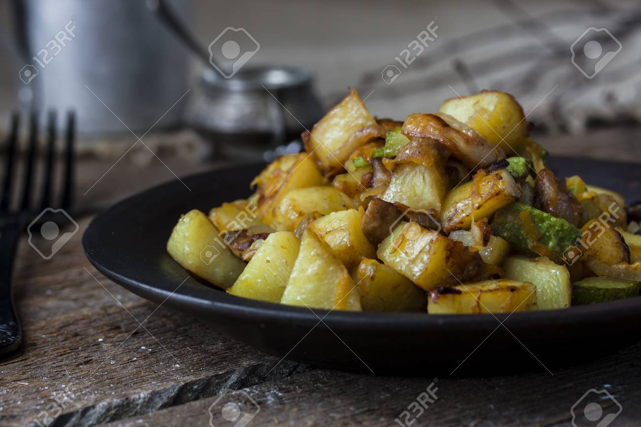 Fried Potatoes With Mushrooms Onions And Zucchini Stock Photo Picture And Royalty Free Image Image 56708524