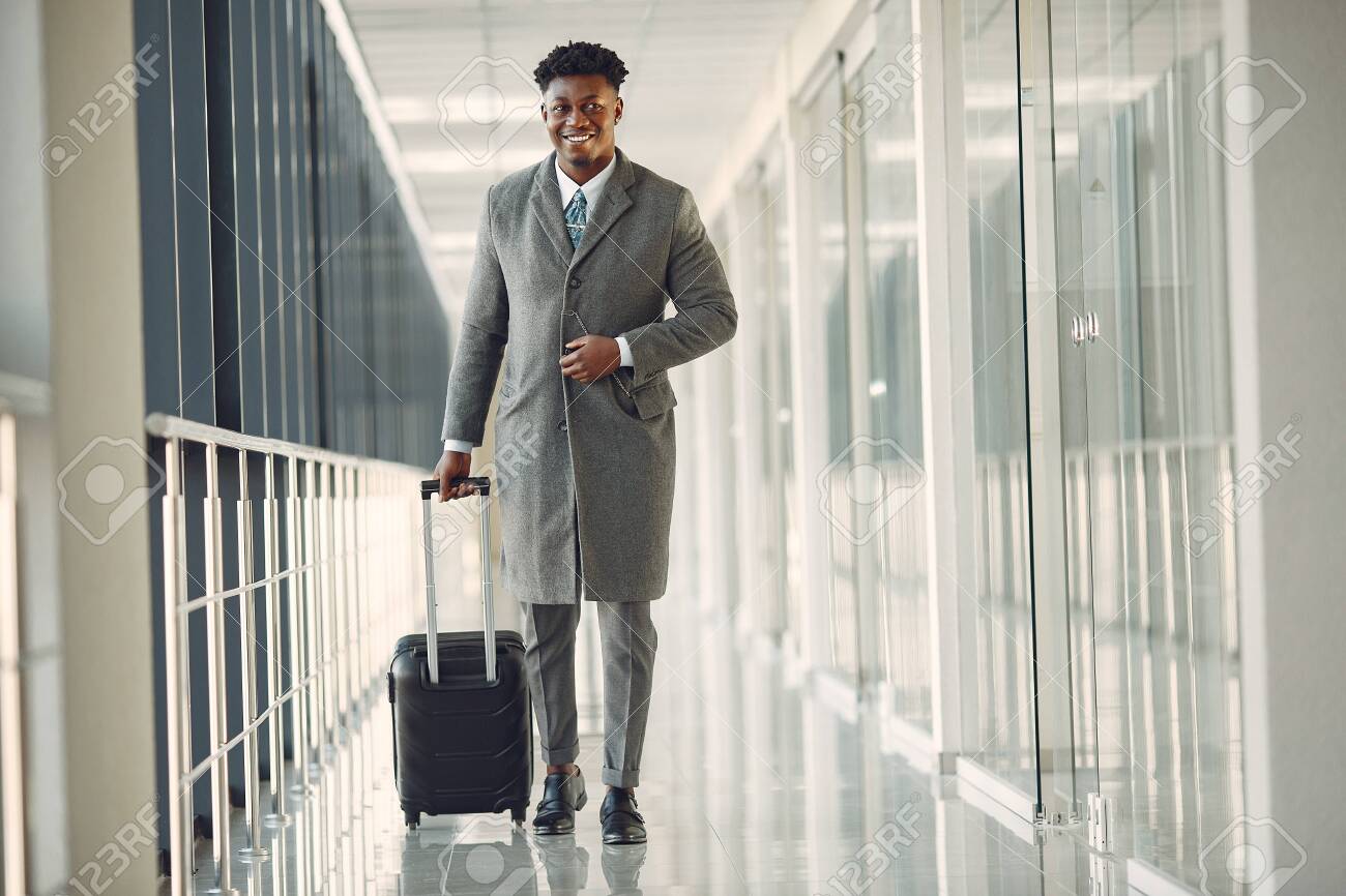 145280932-elegant-black-man-at-the-airport-with-a-suitcase.jpg