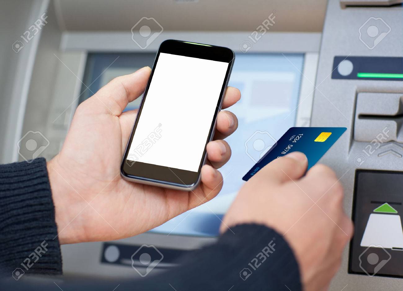 Man Holding Mobile Phone With Isolated Screen And A Credit Card At An Atm Stock Photo Picture And Royalty Free Image Image 33954791<script async src=