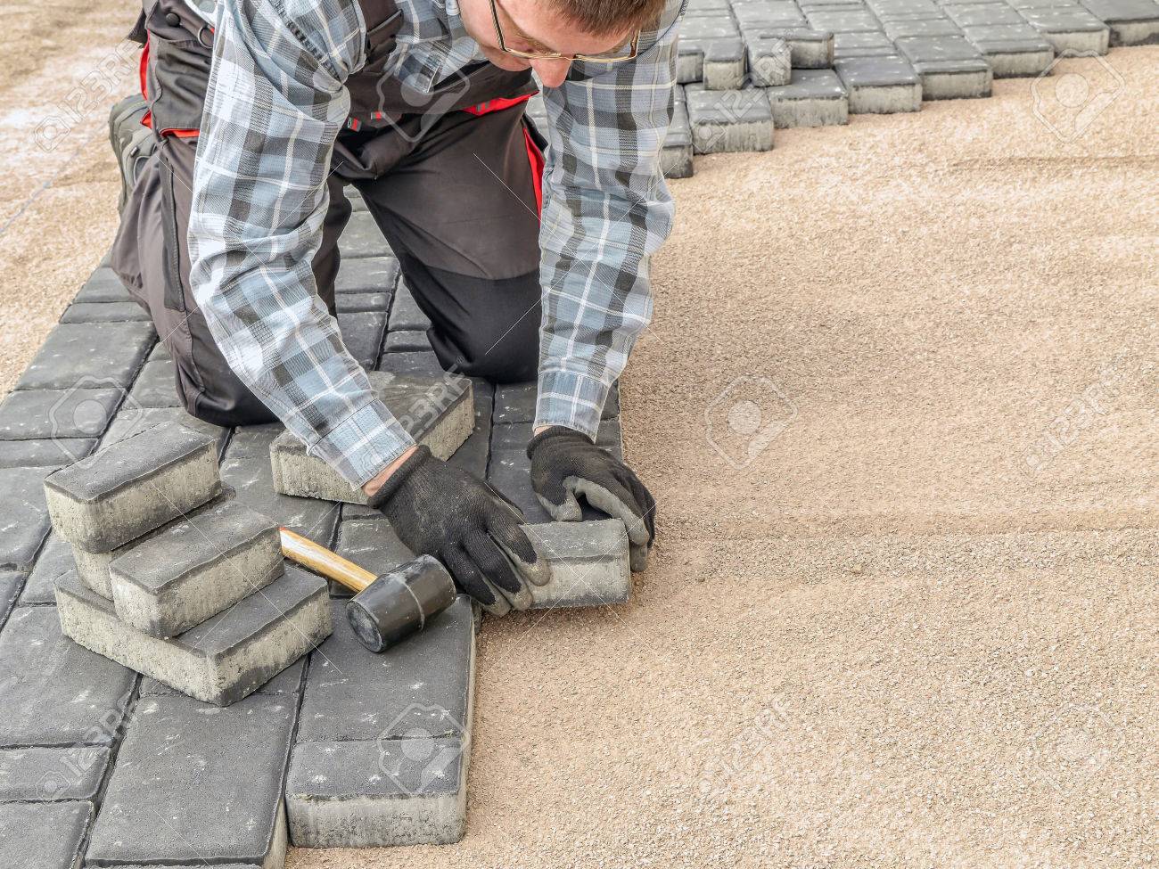 paver laying driveway pavement