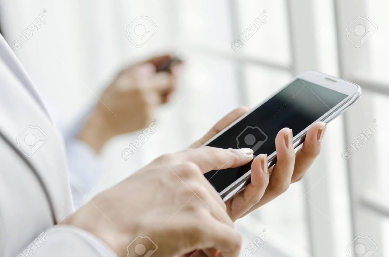 Closeup of business people using smart phone - 23920582 Closeup of business people using smart phone - 23920582