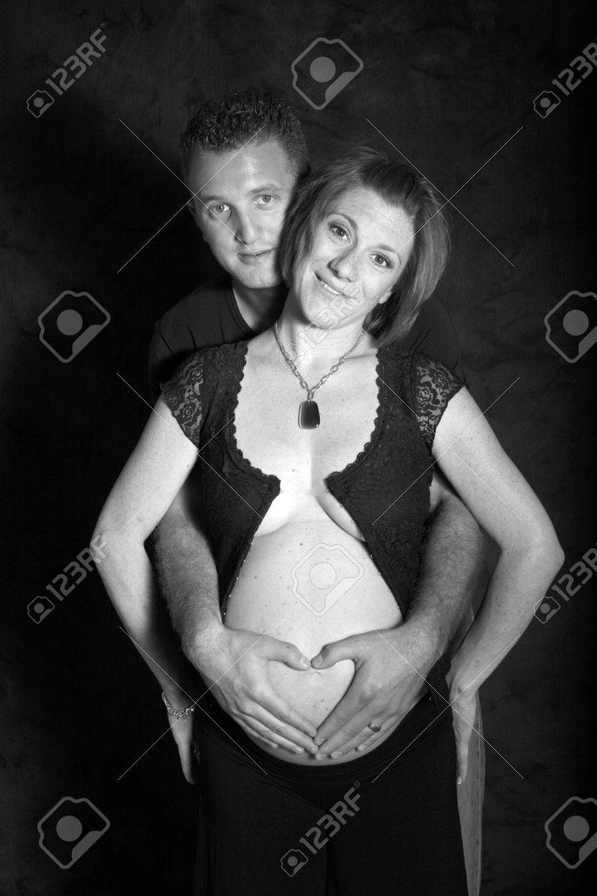 dad places a heart over moms pregnant belly - 1686802 dad places a heart over moms pregnant belly - 1686802