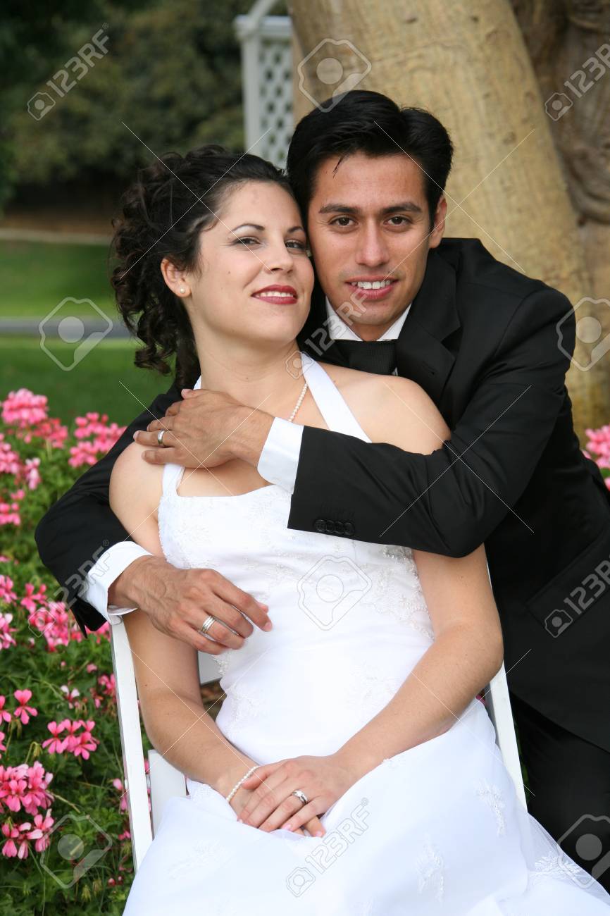 groom puts his arms around his bride - 1686786 groom puts his arms around his bride - 1686786