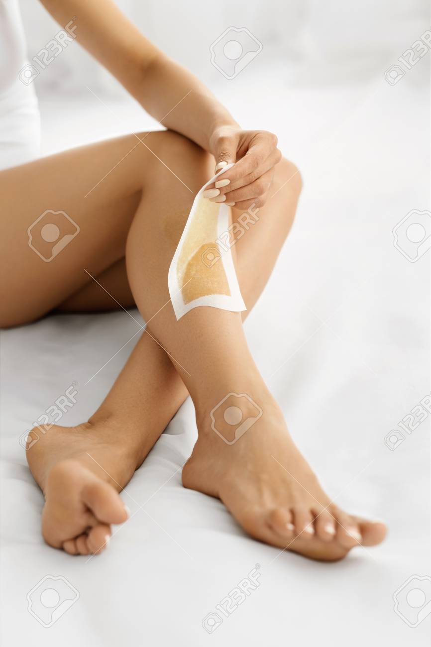 Hair Removal Long Woman Legs With Wax Strip On Closeup Of Female