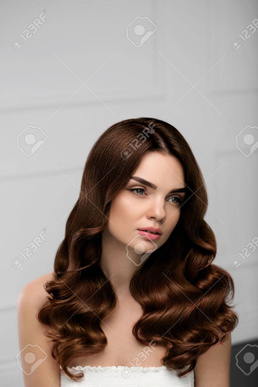 Curly Hair Style. Beautiful Brunette Woman Model With Long Shiny Wavy Hairstyle. Gorgeous Girl With Natural Makeup, Beauty Face, Healthy Soft Skin, Perfect Brown Hair Color And Curls. High Resolution Stock Photo, Curly Hair Style. Beautiful Brunette Woman Model With Long Shiny Wavy Hairstyle. Gorgeous Girl With Natural Makeup, Beauty Face, Healthy Soft Skin, Perfect Brown Hair Color And Curls. High Resolution Stock Photo,