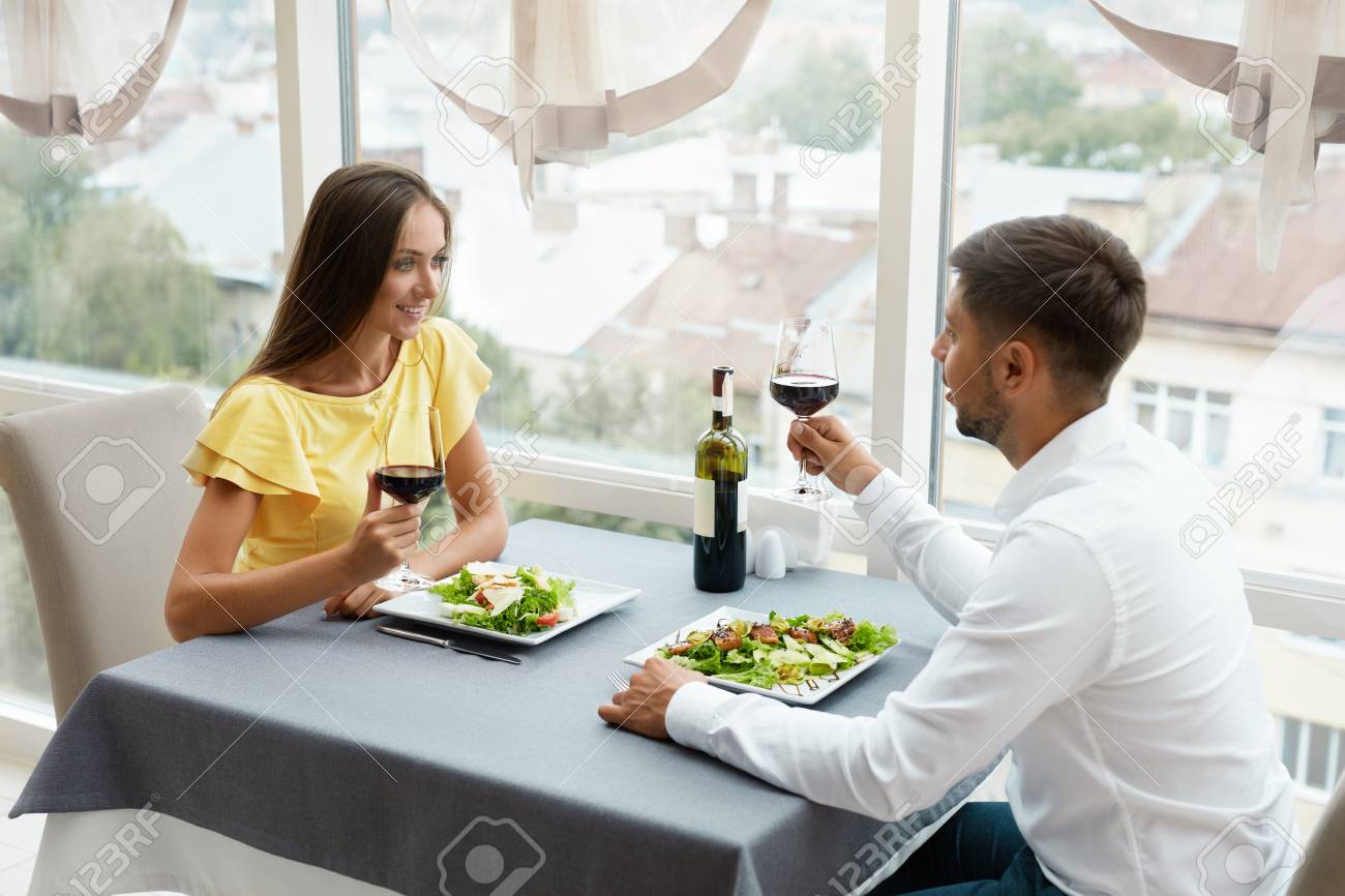 Beautiful Couple In Love On Romantic Date In Restaurant. Happy Smiling Couple Drinking Wine, Eating Salad And Enjoying Romantic Dinner. Relationship. High Quality Image. - 92440153 Beautiful Couple In Love On Romantic Date In Restaurant. Happy Smiling Couple Drinking Wine, Eating Salad And Enjoying Romantic Dinner. Relationship. High Quality Image. - 92440153