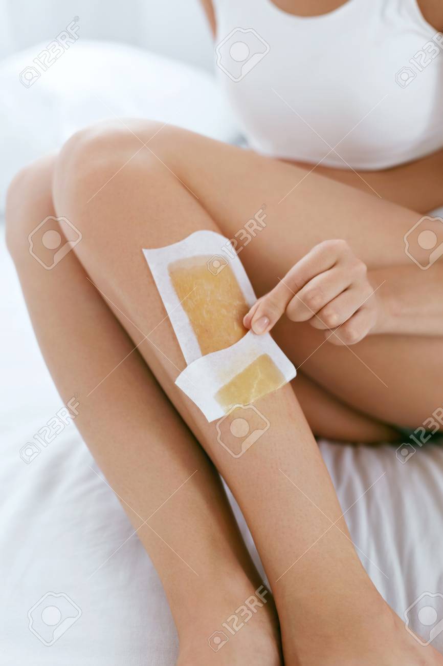Long Woman Legs With Hair Wax Strip Closeup Beautiful Female