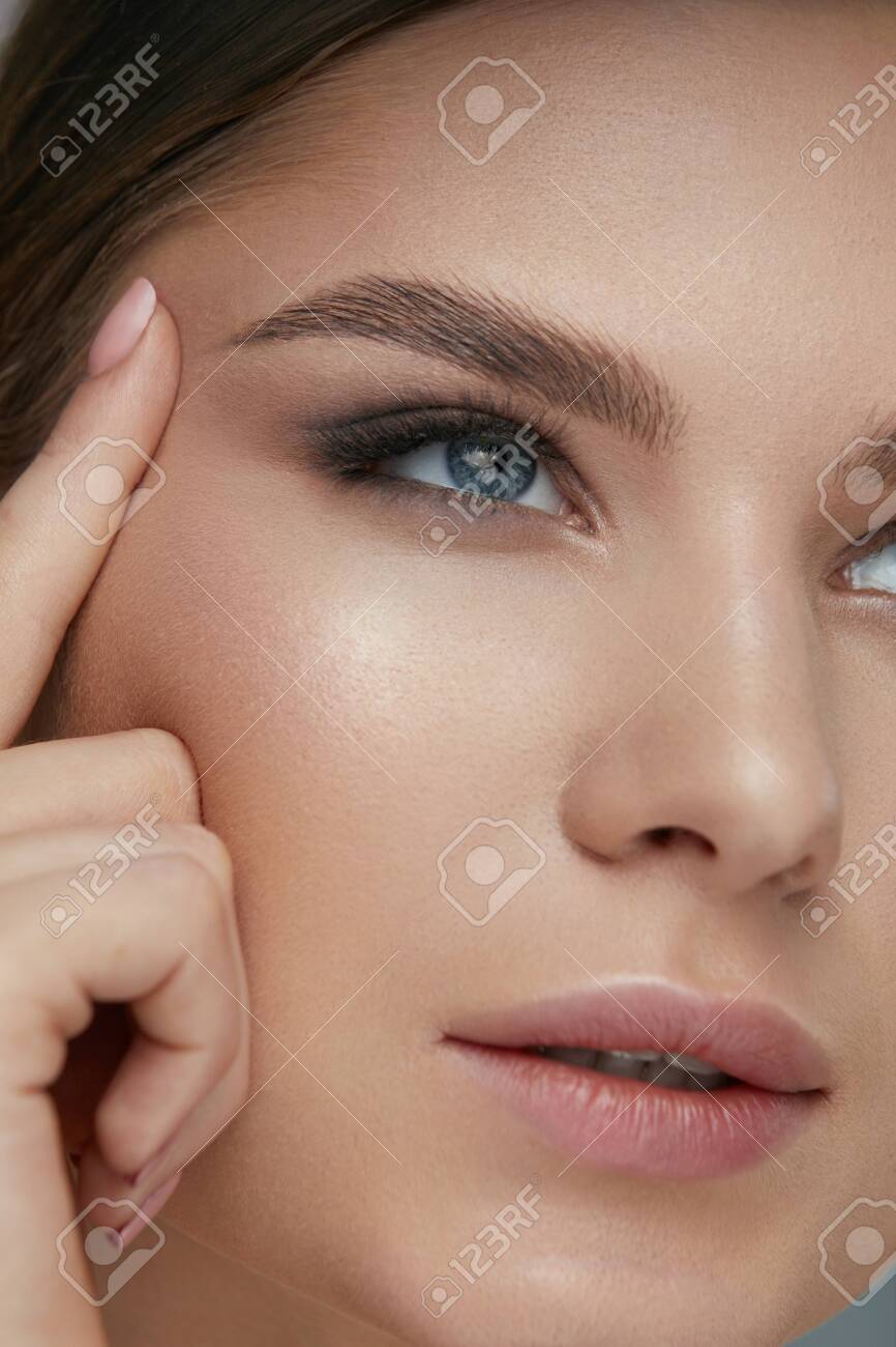 Beauty Face Makeup. Woman With Beautiful Eyes And Eyebrows Make-up Closeup.  Girl Model Lifting Eye Skin With Finger Stock Photo, Picture and Royalty  Free Image. Image 124524169., image size:866x1300