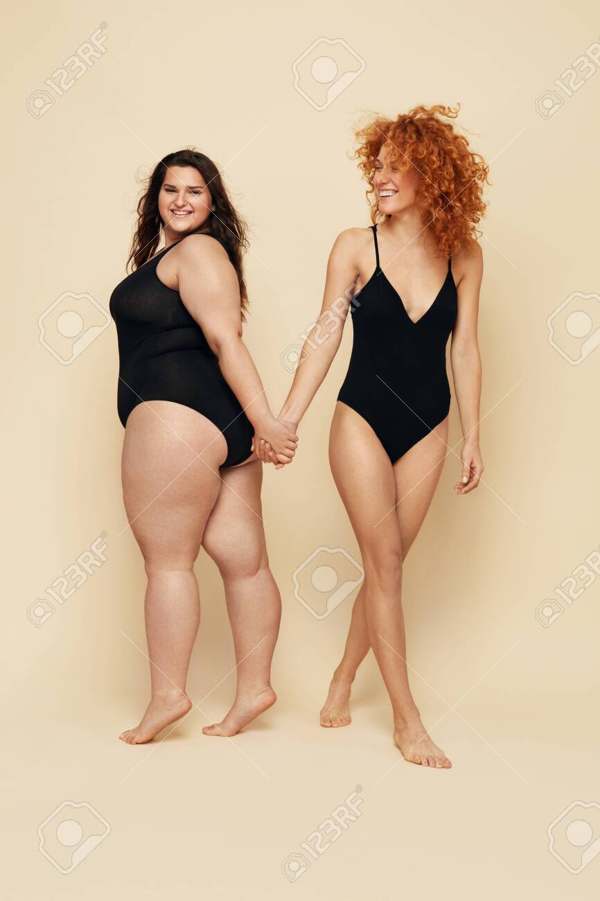 Different Size Diversity Women Full Length Portrait Smiling Brunette And Redhead In Black Bodysuits Posing On Beige Background Female Friendship Stock Photo Picture And Royalty Free Image Image