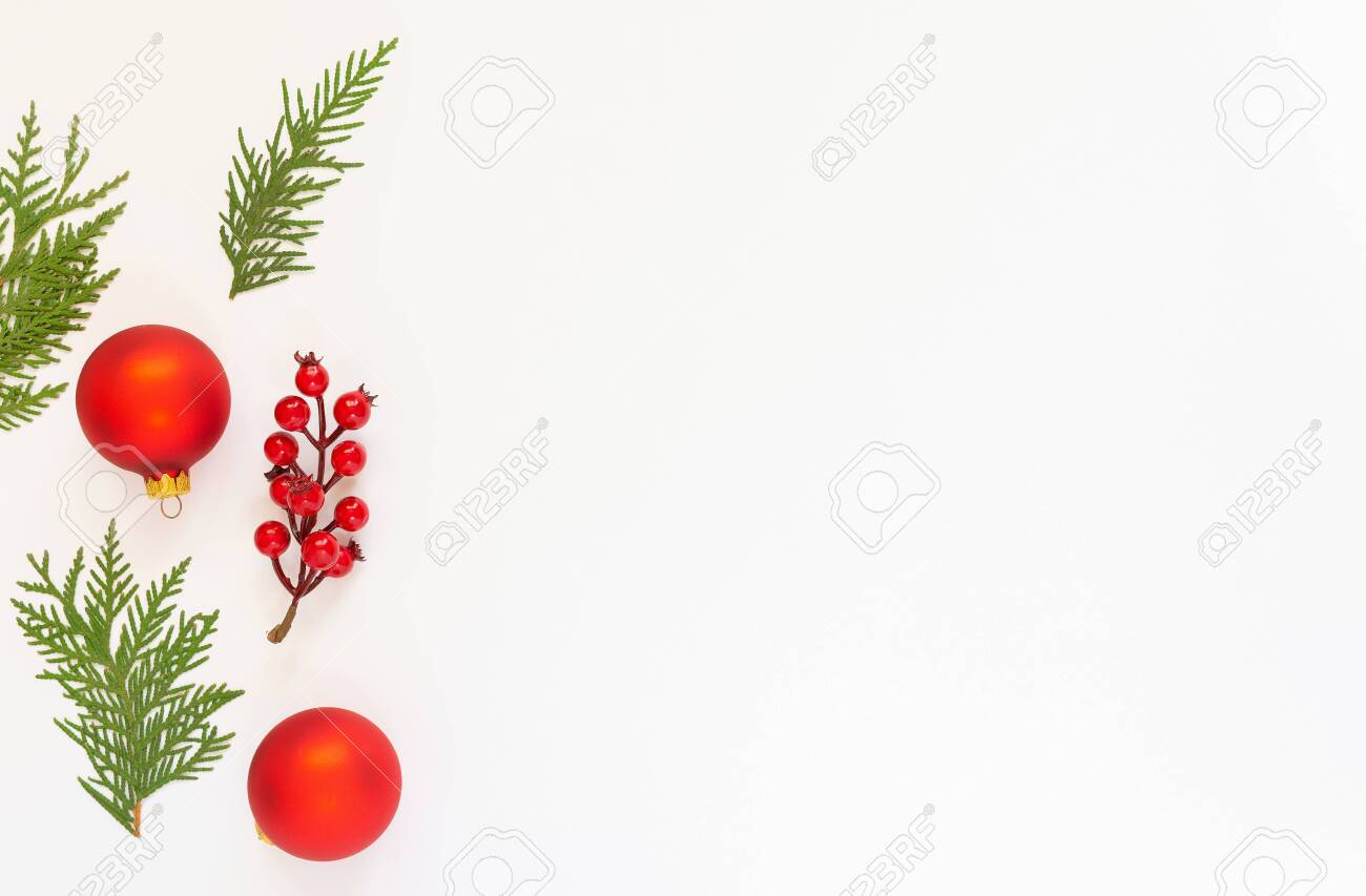 Festive background, branch of hawthorn and Christmas tree balls with fir twigs on a white background, flat lay, top view, copy space - 136311621 Festive background, branch of hawthorn and Christmas tree balls with fir twigs on a white background, flat lay, top view, copy space - 136311621