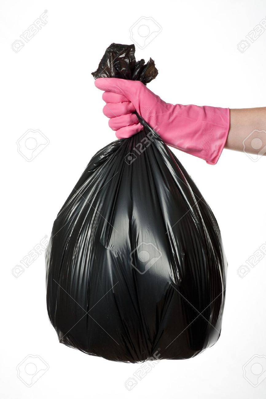 Hand holding a full black plastic trash bag - 18904251 Hand holding a full black plastic trash bag - 18904251