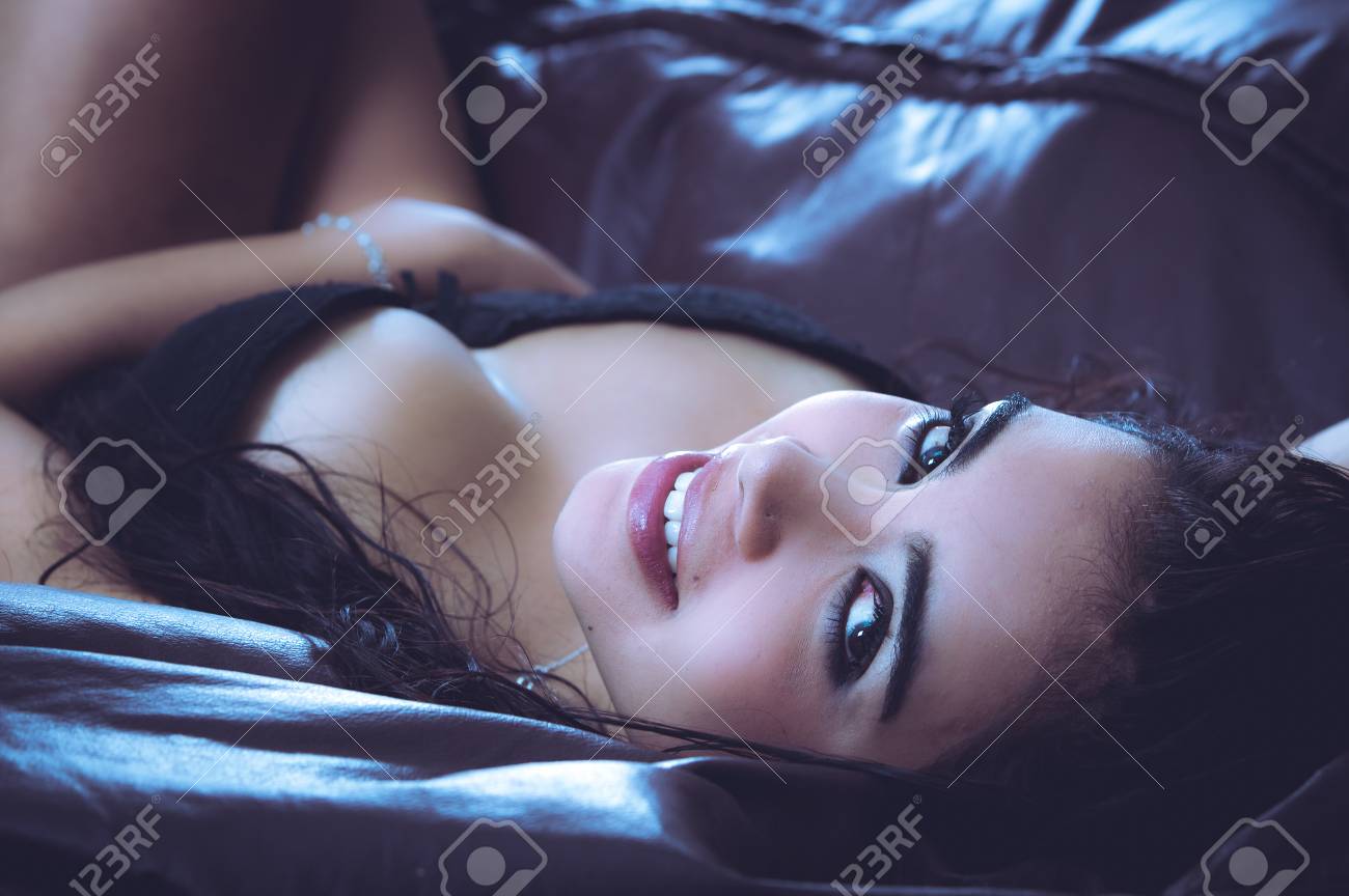 Sexy Latina Model Lying In Seductive Position Revealing Some Skin And  Looking Into Camera From Above Her Head. Stock Photo, Picture and Royalty  Free Image. Image 44691804.