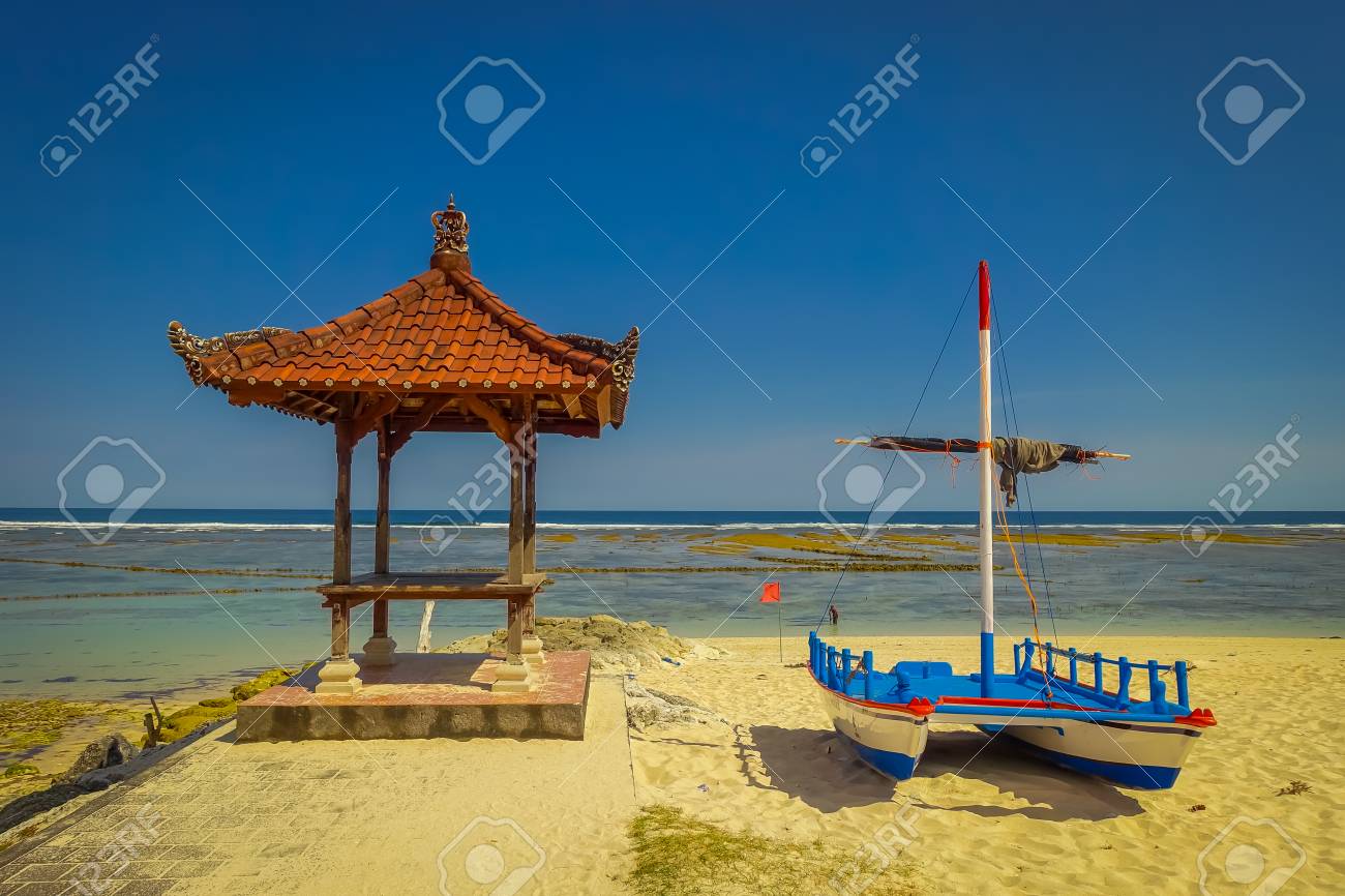 Beautiful Sunny Day With A Boat On The Yellow Sand In The Beach