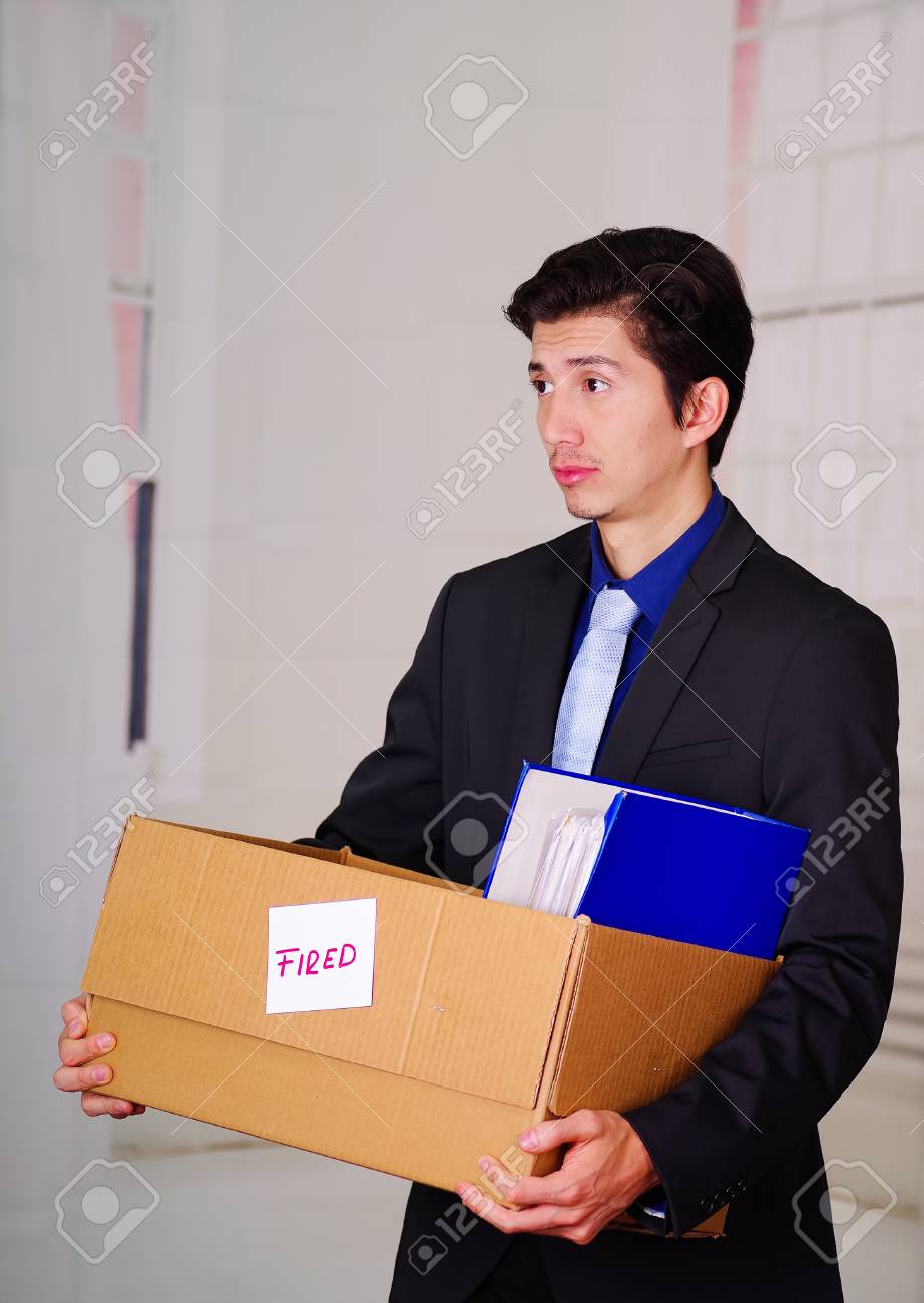 close up of sad man holding a box after being fired from his stock how to get a job after being fired