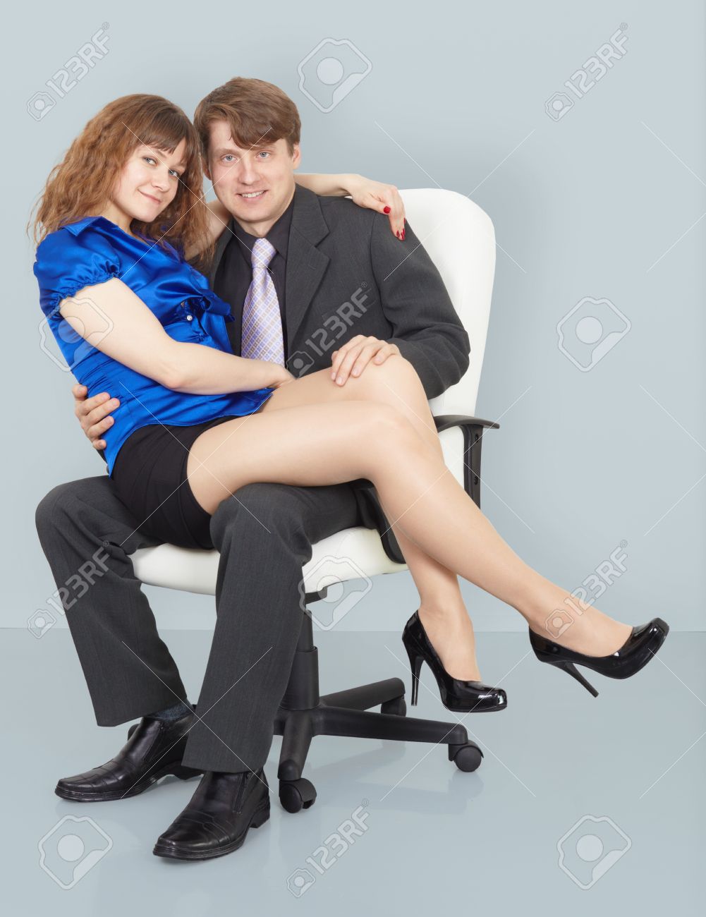 Young Woman Sitting On The Lap Of A Man Sitting In A Chair Stock Photo Picture And Royalty Free Image Image
