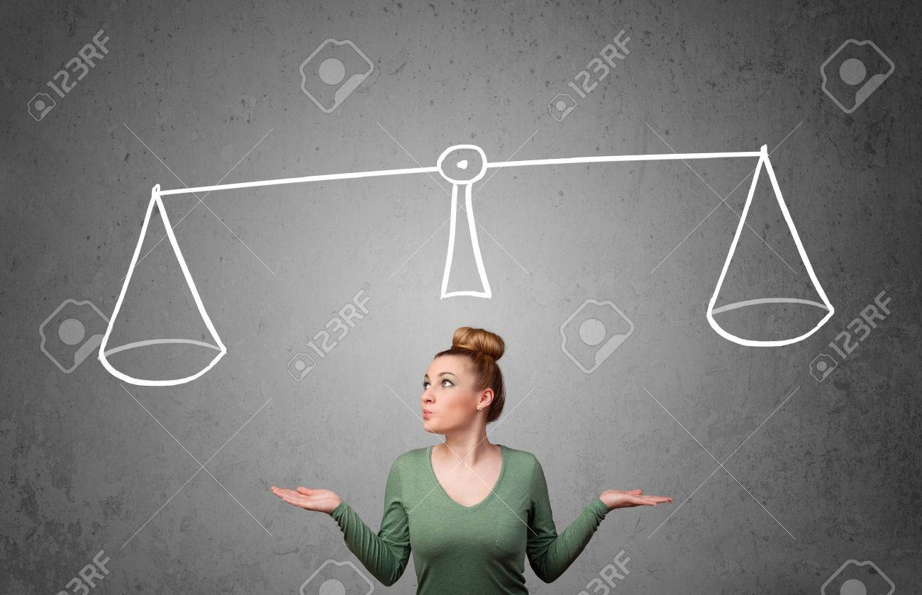 Pretty young lady taking a decision with scale above her head - 22959396 Pretty young lady taking a decision with scale above her head - 22959396