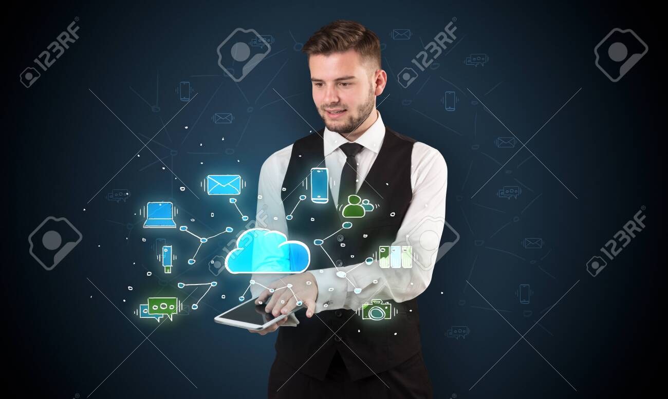 Chalk drawn cloud technology symbols on a tabled handled by businessman - 121099807 Chalk drawn cloud technology symbols on a tabled handled by businessman - 121099807