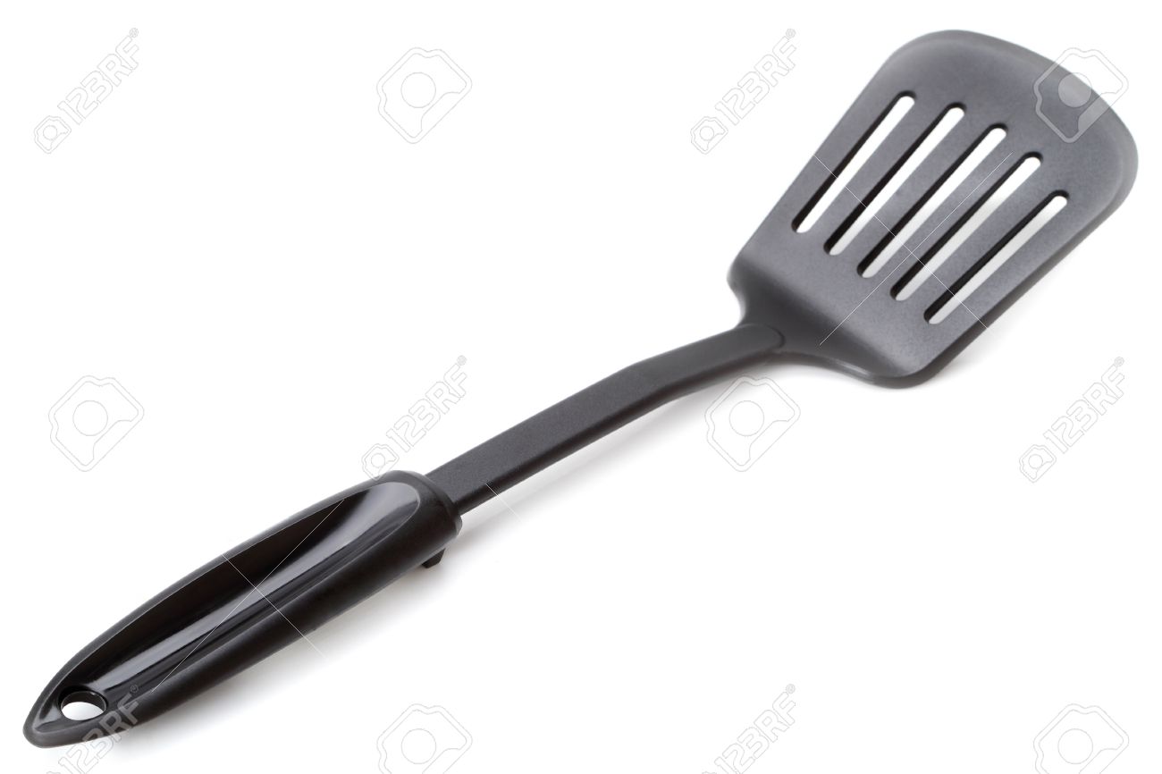 White Kitchen Utensils slotted spatula - kitchen utensils isolated on a white background White Kitchen Utensils slotted spatula - kitchen utensils isolated on a white background