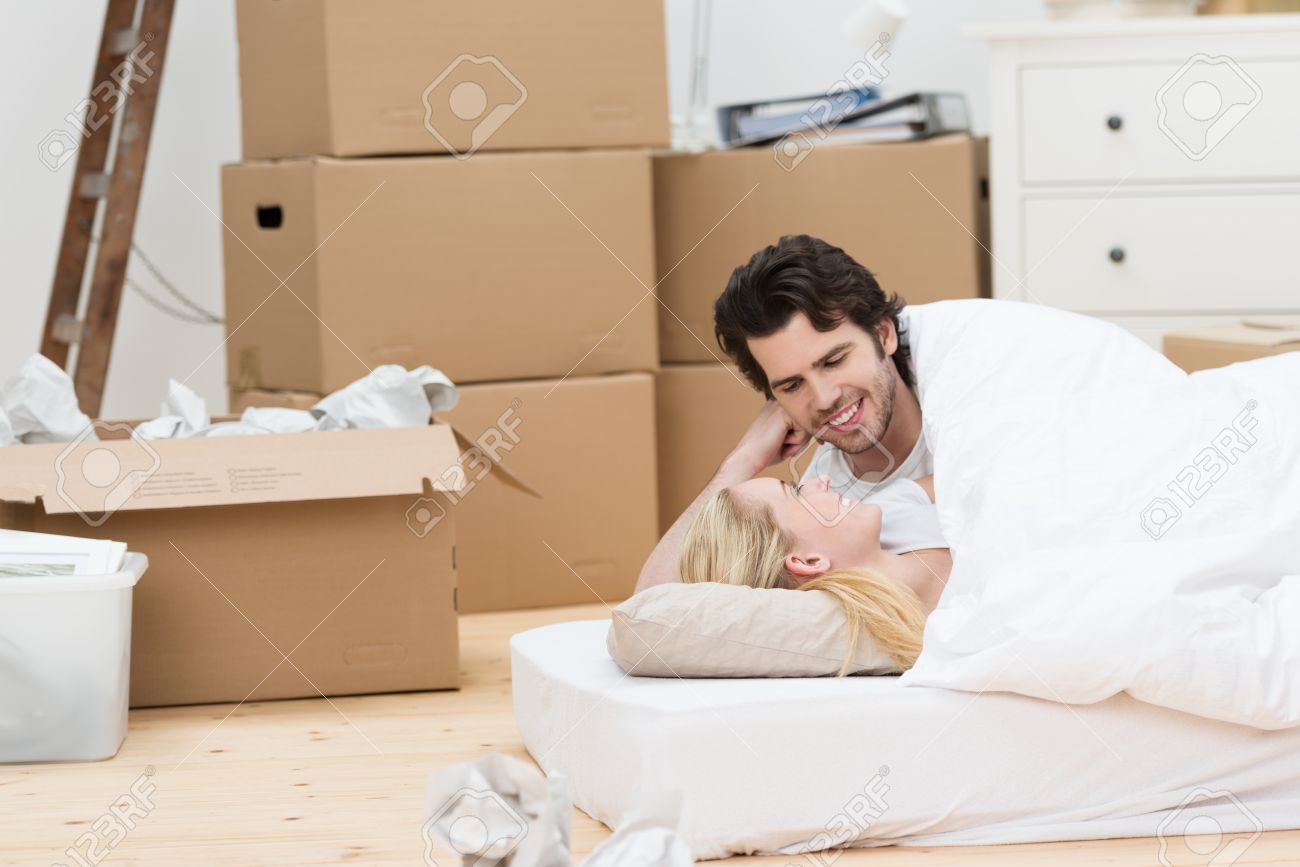 Loving Couple Sleeping On The Floor On A Mattress Surrounded