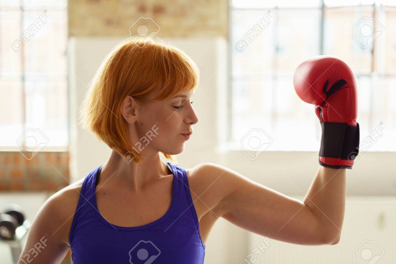 contrastwerkstattBoxing Glove In A Gym Flexing Her Arm