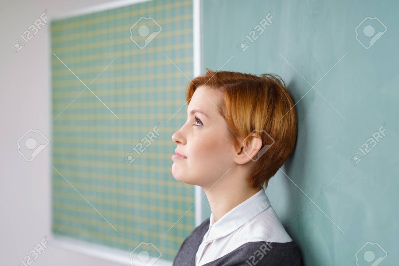 Side Portrait Of Young Red Haired Woman With Short Haircut Leaning
