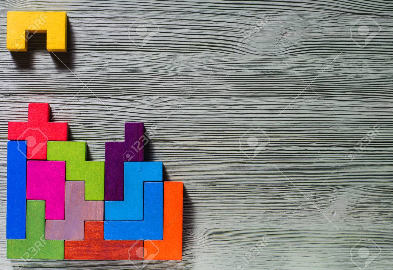 The concept of logical thinking. Geometric shapes on a wooden background. Tetris toy wooden blocks. - 69025233 The concept of logical thinking. Geometric shapes on a wooden background. Tetris toy wooden blocks. - 69025233