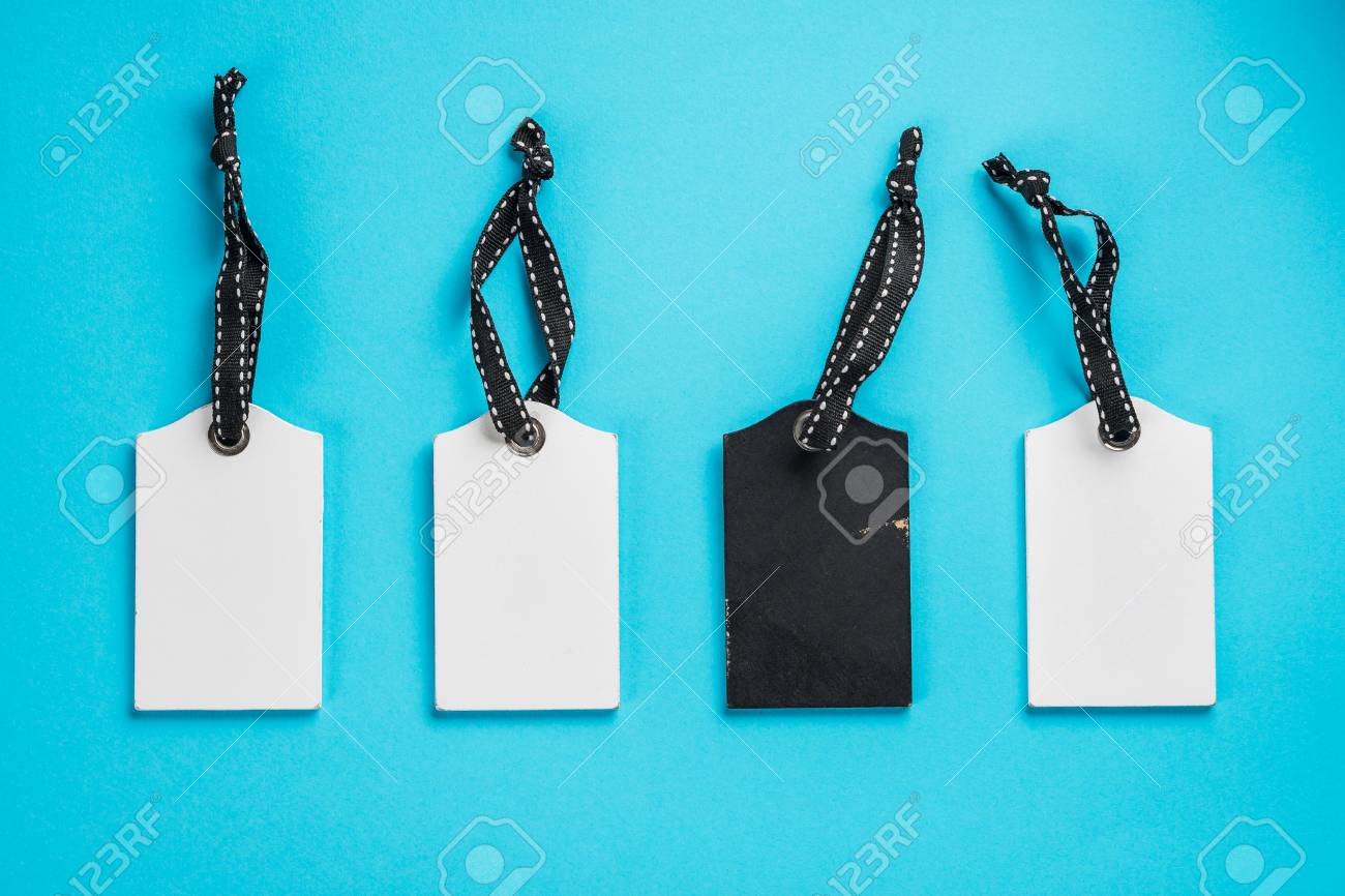 empty white and black tags in a row on blue background top stock