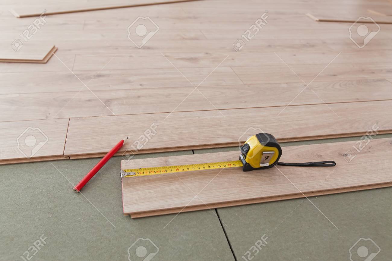 Laying Of Vinyl Floor Close Up Of Material And Tools During Work