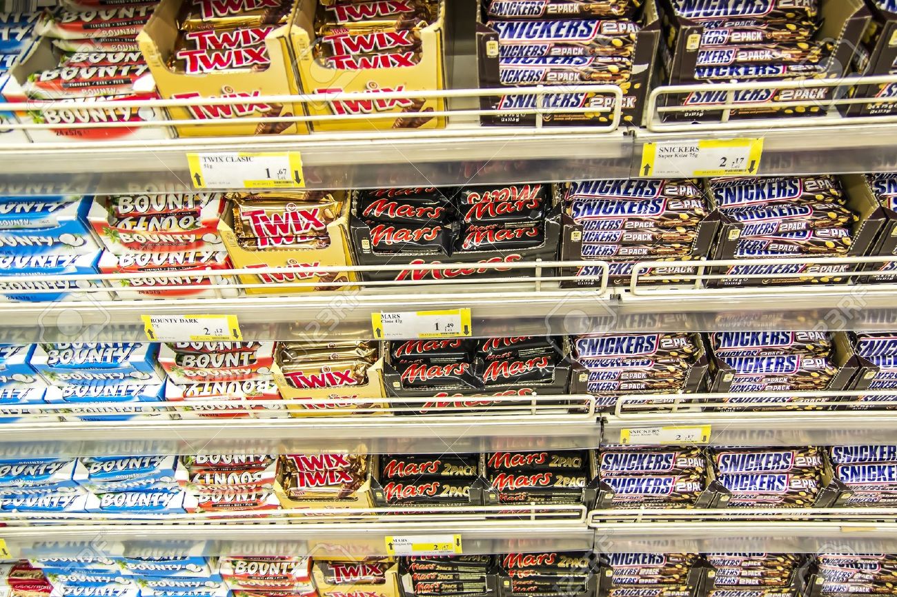 supermarket shelves stacked with chocolate bars snickers twix mars supermarkets