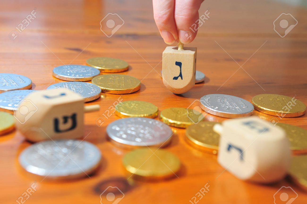 Photo Of Someone Spinning A Spinning Top (dreidel) And Gelt (candy Coins)  For Hanukkah Stock Photo, Picture and Royalty Free Image. Image 37027663.