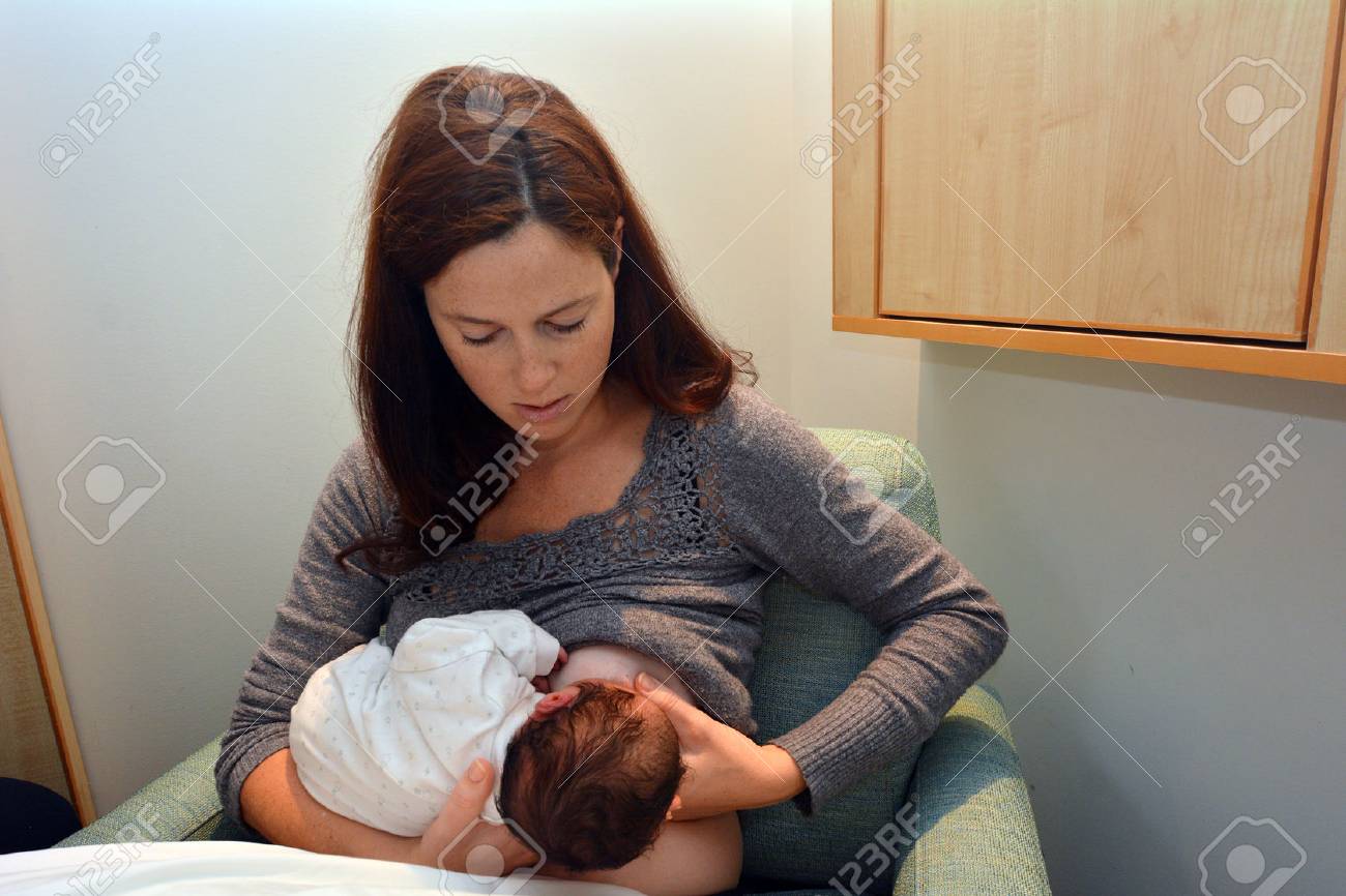 Young mother Breastfeeding her Newborn in hospital for the first time. - 46958405 Young mother Breastfeeding her Newborn in hospital for the first time. - 46958405