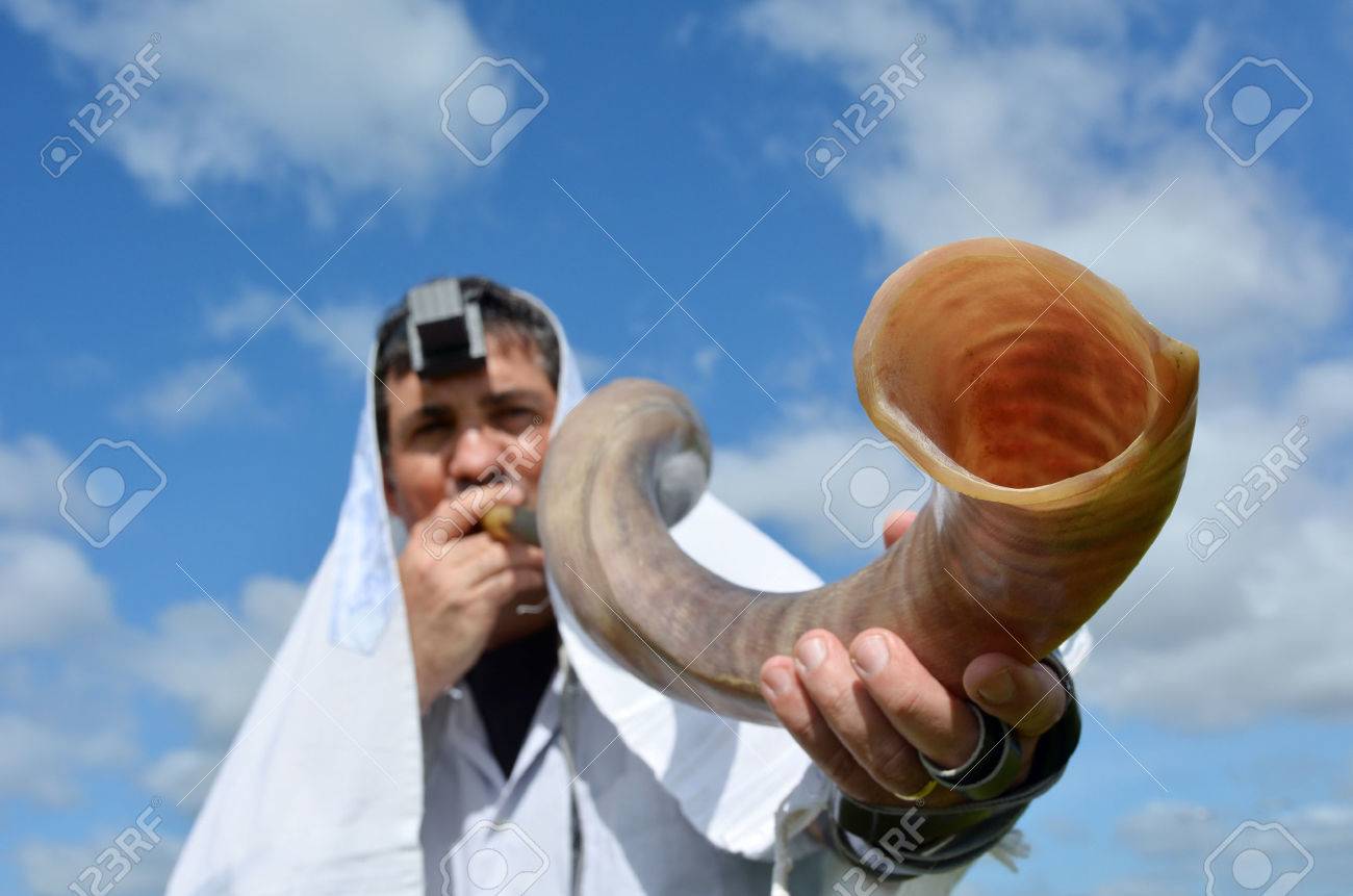 Jewish man blow Shofar outdoors under the sky, on the Jewish High Holidays in Rosh Hashanah and Yom Kippur - 48521777 Jewish man blow Shofar outdoors under the sky, on the Jewish High Holidays in Rosh Hashanah and Yom Kippur - 48521777