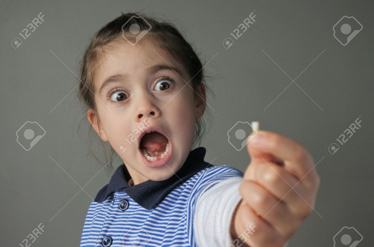 Young girl (age 6) surprise to find that she have lost her first bottom front milk teeth. Childhood healthcare concept. real people copy space - 62201464 Young girl (age 6) surprise to find that she have lost her first bottom front milk teeth. Childhood healthcare concept. real people copy space - 62201464