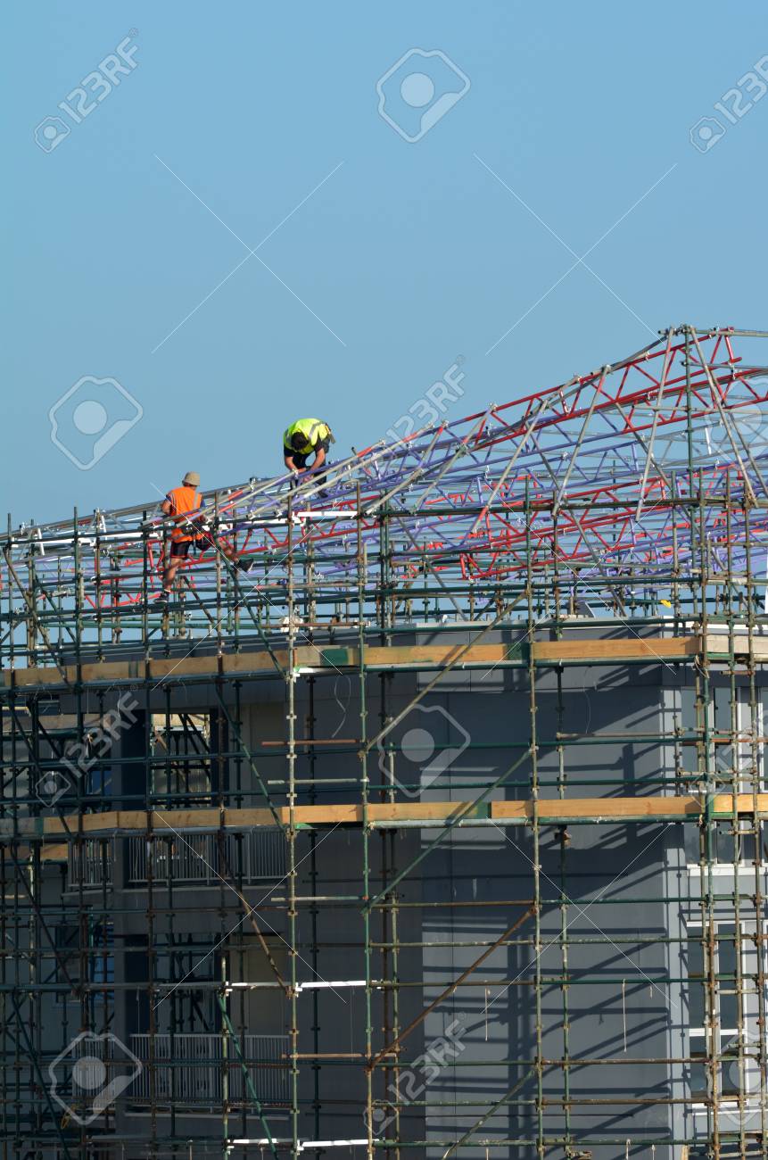 unrecognisable construction workers on a scaffold building stock scaffold building