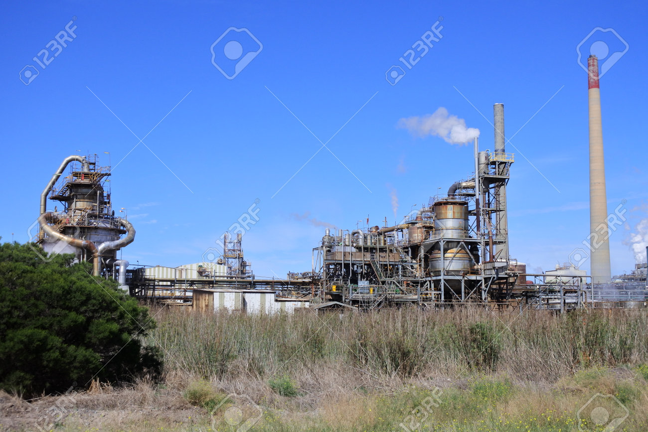 Industrial chimney with smoke against a clear blue sky. Environmental concept.No people. Copy space - 168379569 Industrial chimney with smoke against a clear blue sky. Environmental concept.No people. Copy space - 168379569