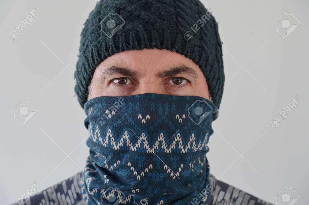 Middle Eastern Militant Man disguising his identity by wearing a beanie and balaclava face cover looking at camera. - 169904717 Middle Eastern Militant Man disguising his identity by wearing a beanie and balaclava face cover looking at camera. - 169904717