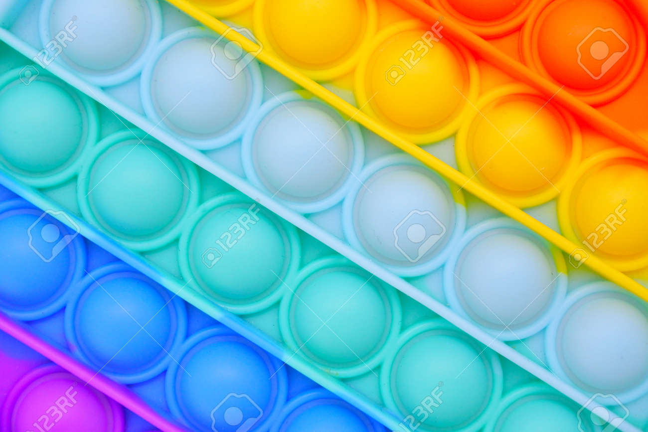 Push pop it bubble fidget sensory toy in rainbow colors abstract background and texture. - 169904765 Push pop it bubble fidget sensory toy in rainbow colors abstract background and texture. - 169904765