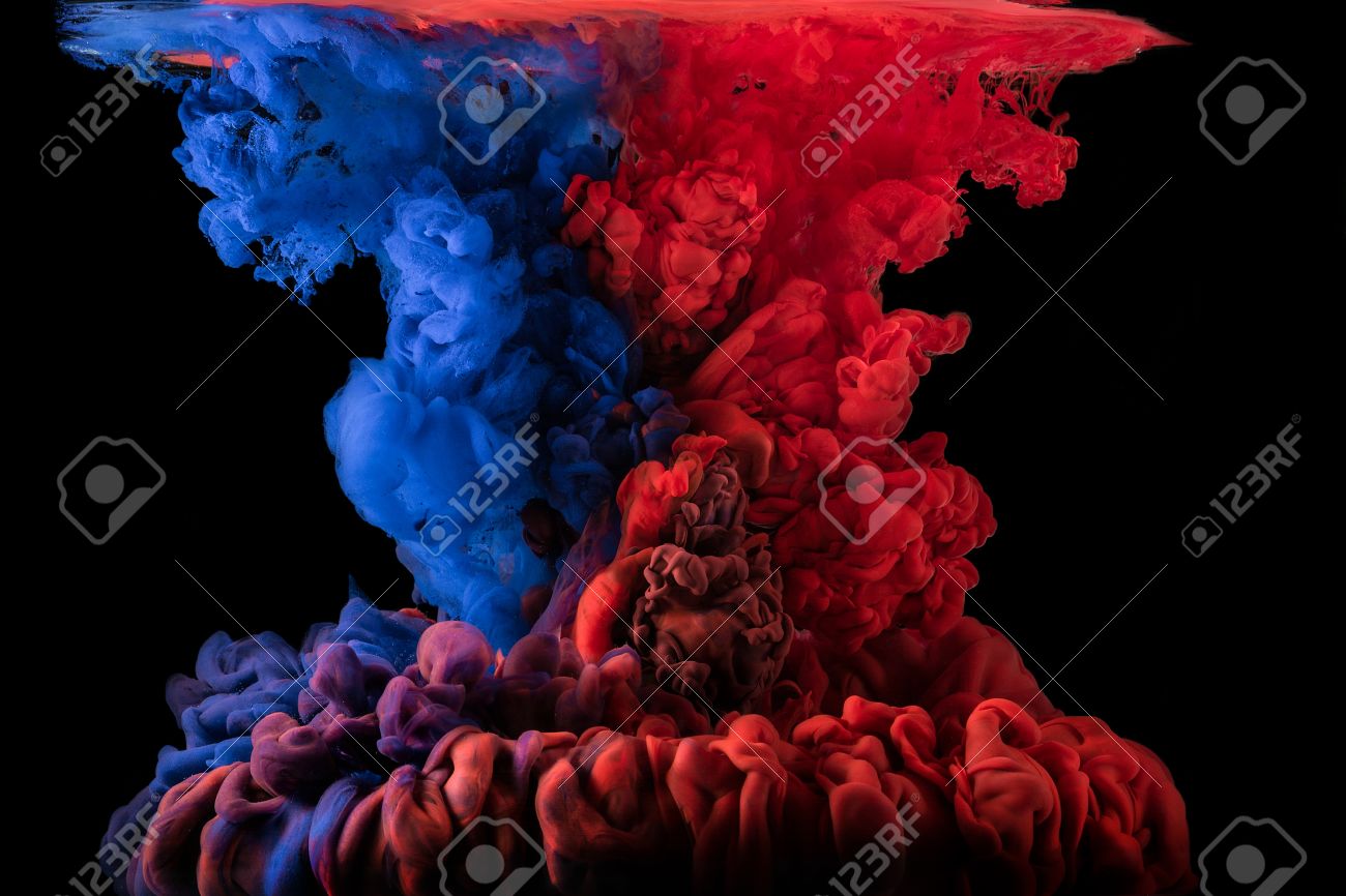 ink mixing together under water on black background red and stock