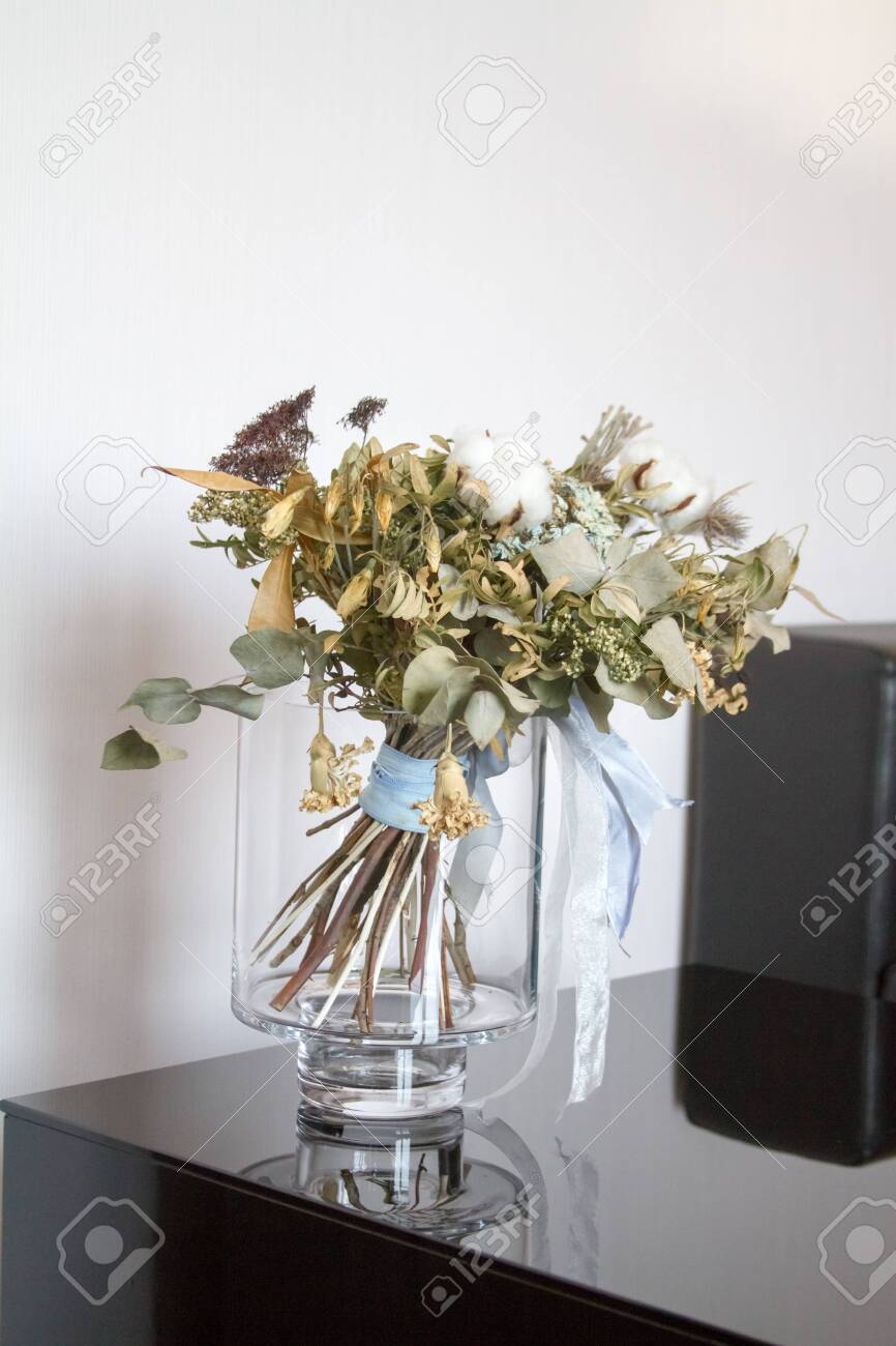 Bouquet Of Dried Flowers In A Glass Vase With Reflection On The