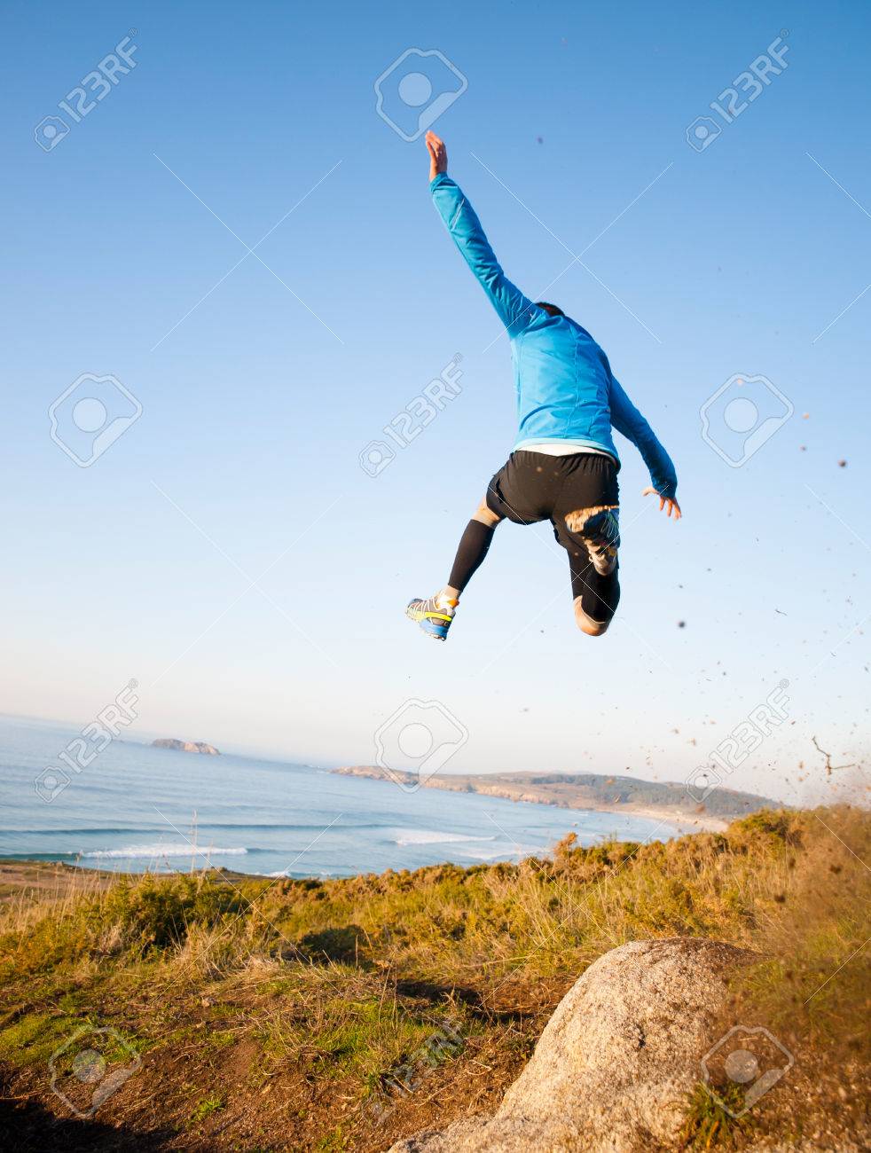 Man Giving A Big Jump While Practicing Trail Running With A Coastal Stock Photo Picture And Royalty Free Image Image