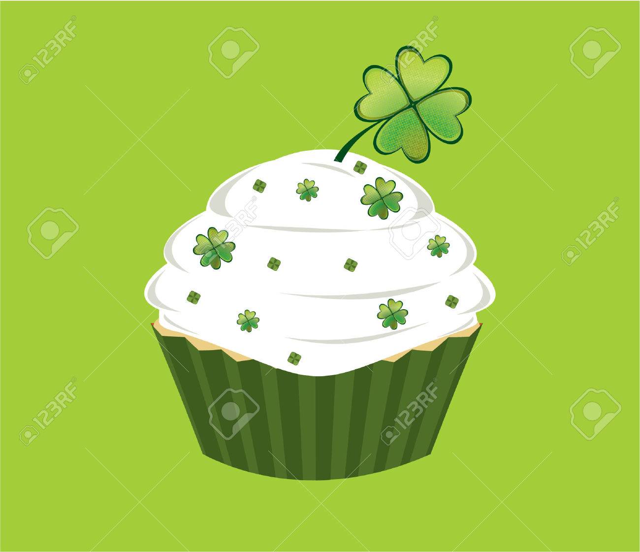 Cupcake decorated with green diamond shapes and shamrocks on white frosted in front of a white background - 6468320 Cupcake decorated with green diamond shapes and shamrocks on white frosted in front of a white background - 6468320