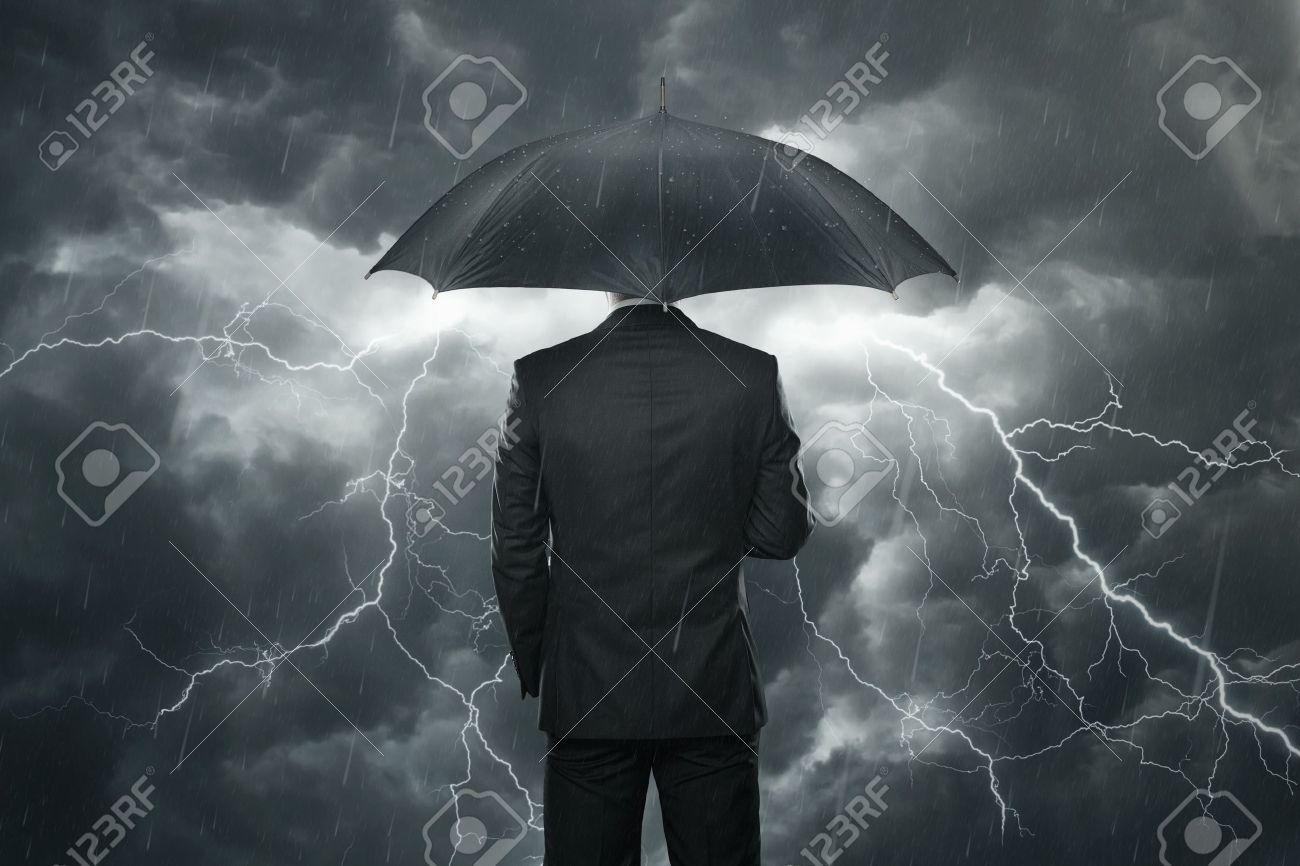 trouble ahead concept businessman with umbrella standing in stock