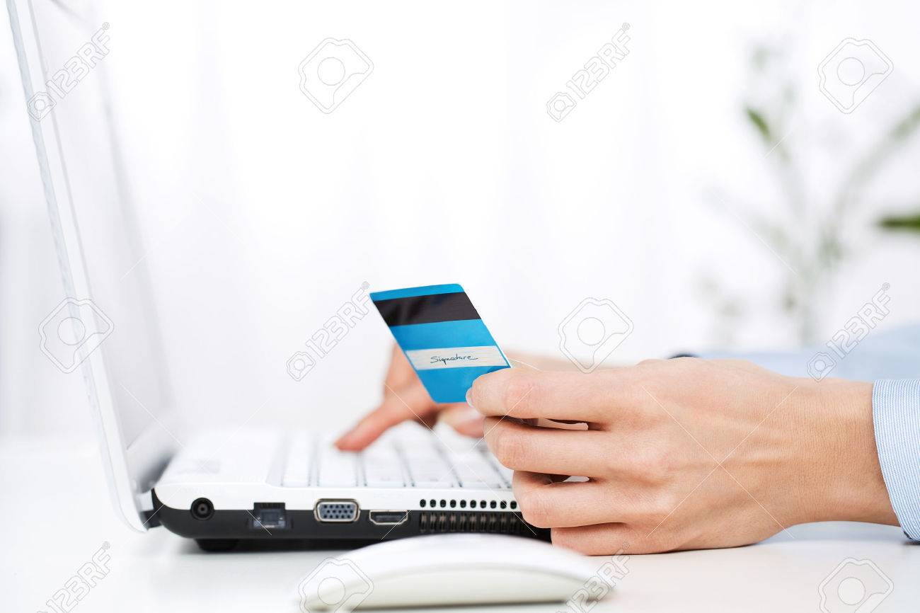 Close up of young woman using credit card - 25305448 Close up of young woman using credit card - 25305448
